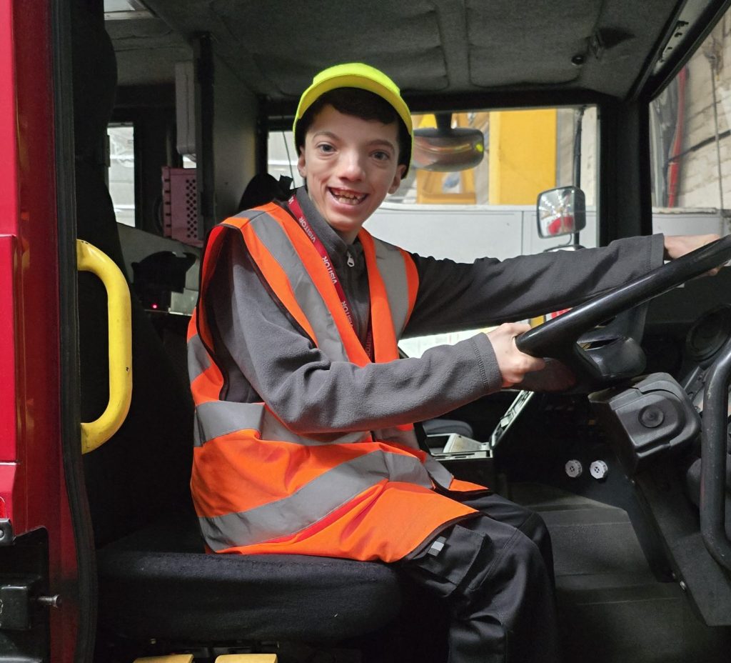 Tighe Jones sat in a fire engine.